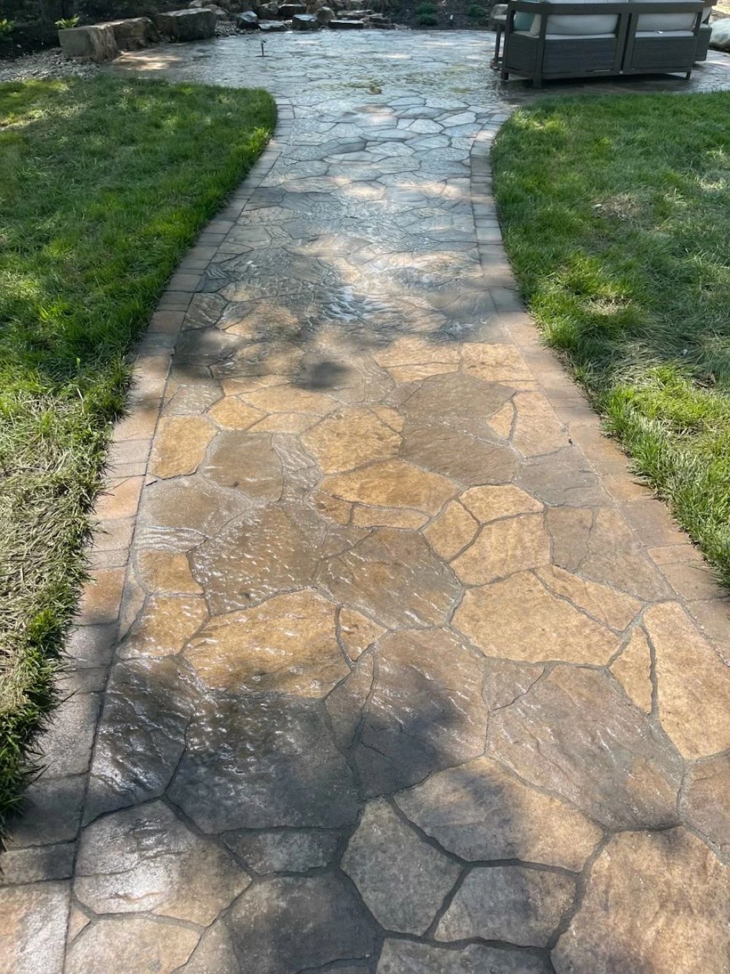 Stamped stone walkway between two lawns