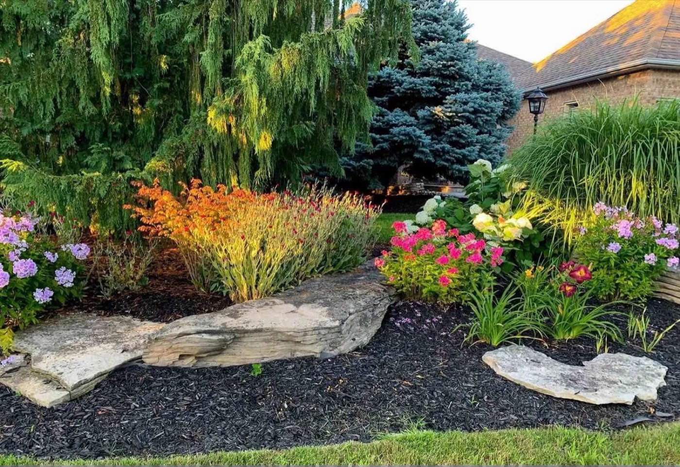 Planting bed with limestone boulders, ornamental grasses and flowers
