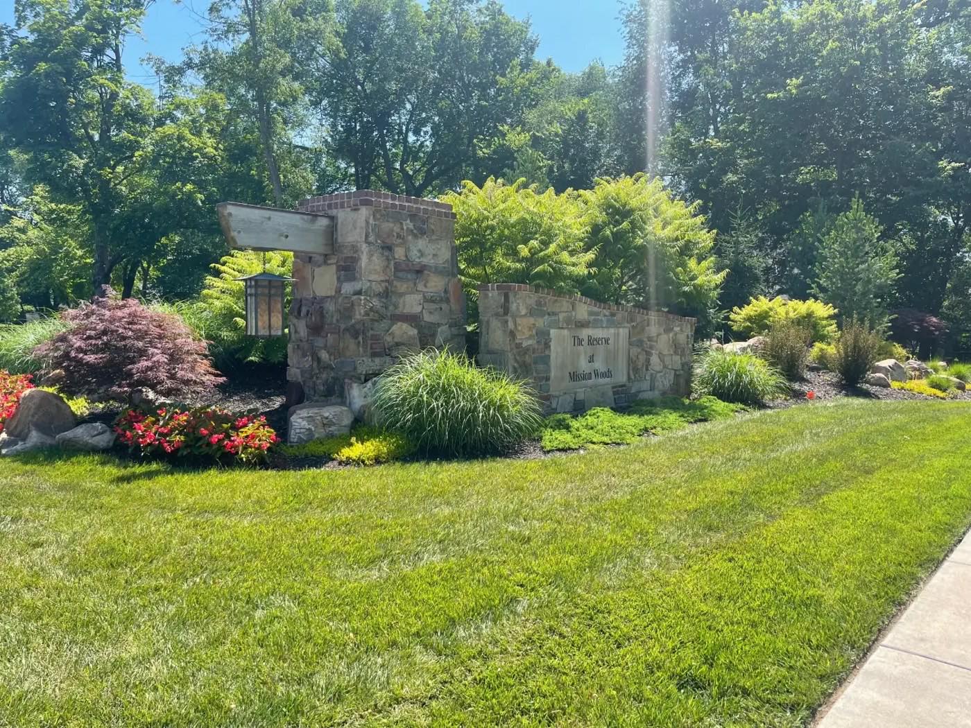 Stone entrance monument and landscaping at The Reserve at Mission Woods